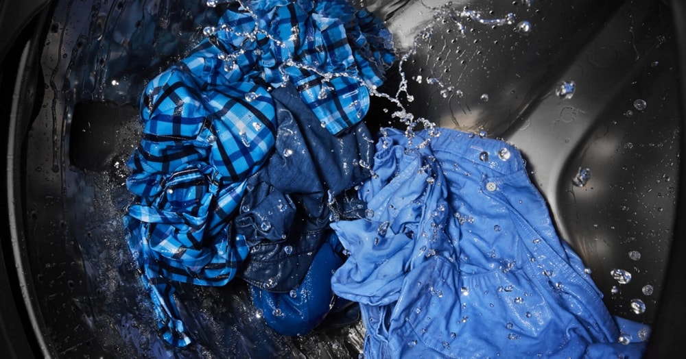 Clothes tumbling in a washing machine.