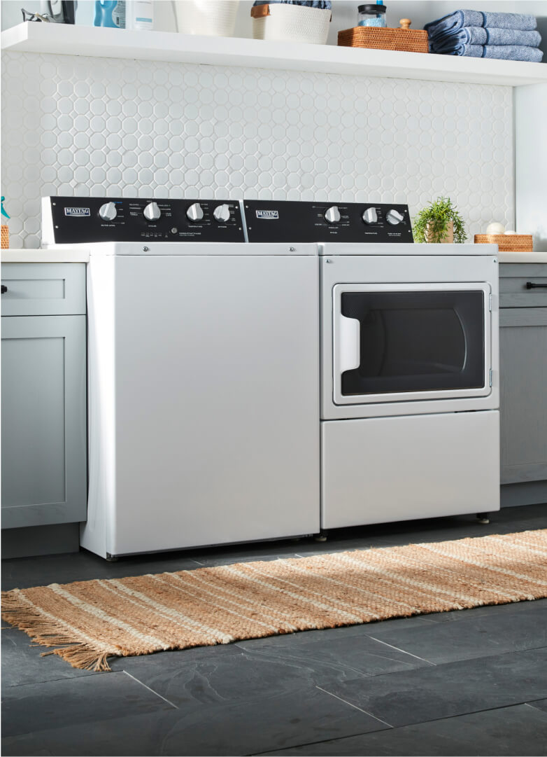 Commercial-grade washer and dryer in a home laundry room.