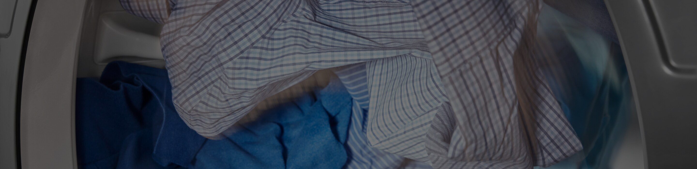 Clothes tumble drying in a Maytag dryer.