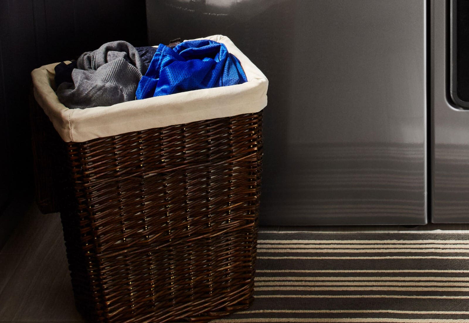 A hamper filled with laundry sorted by color A hamper filled with laundry sorted by color