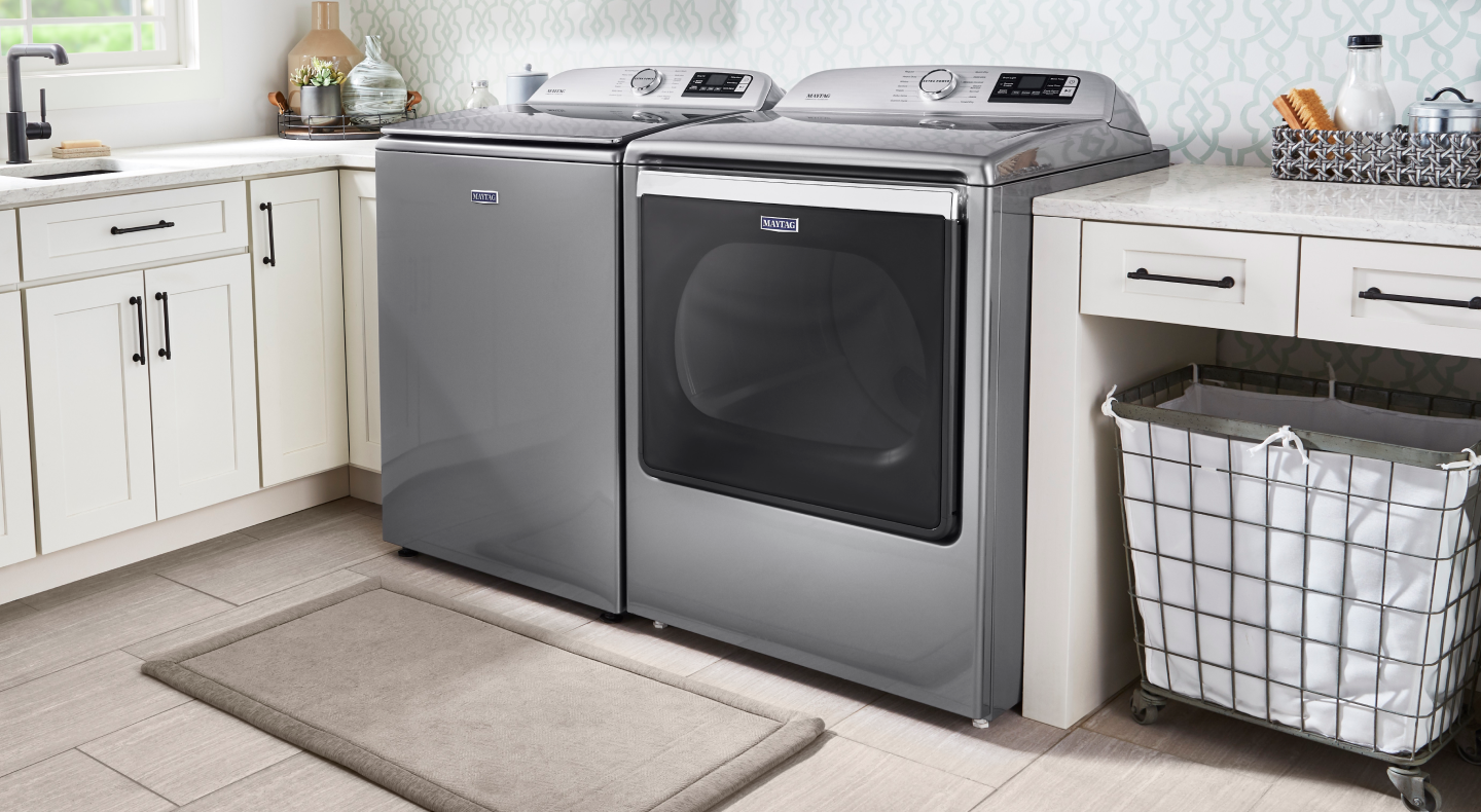 Maytag® top load washer and dryer set in a bright laundry room