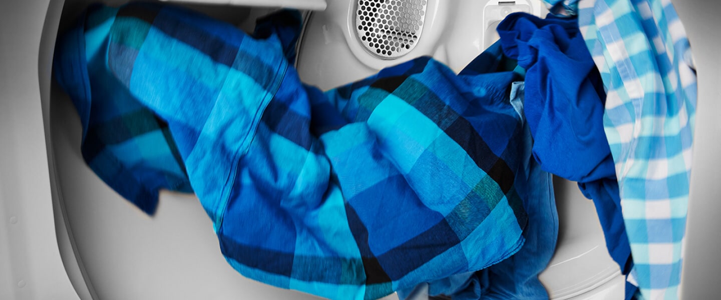Blue clothes tumbling in a dryer Blue clothes tumbling in a dryer.