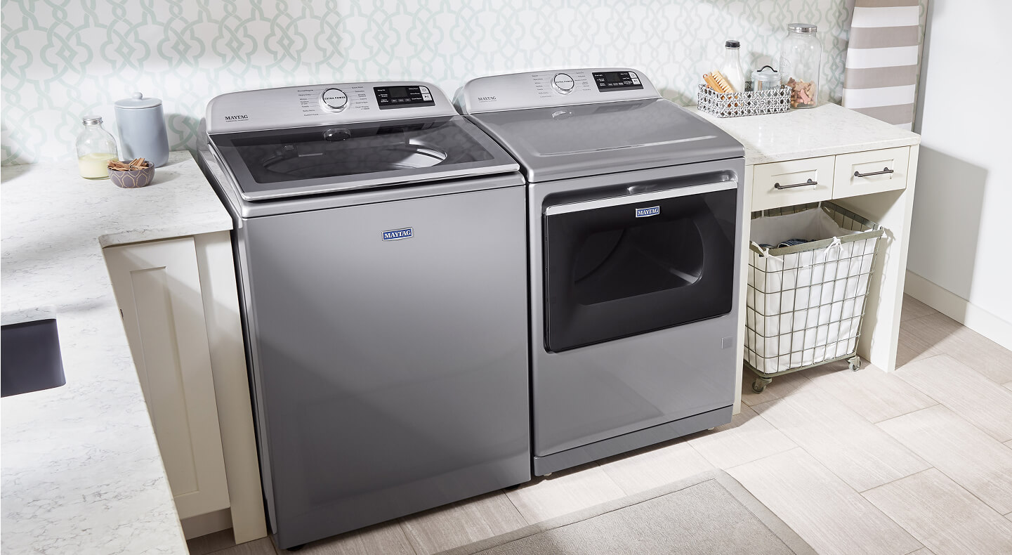 Top-load, glass lid Maytag® washer and dryer in laundry room
