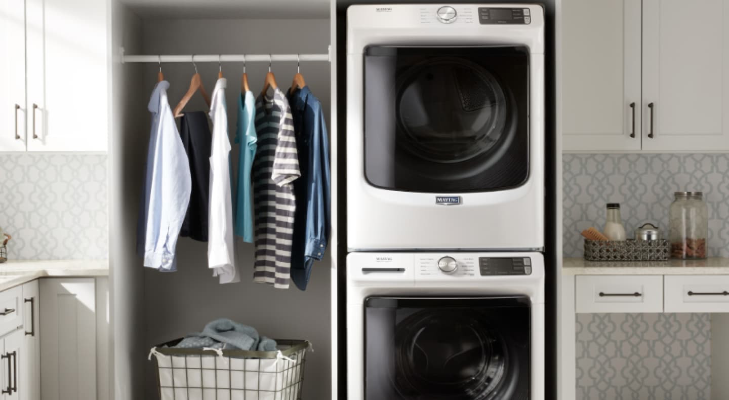 Maytag® stacked washer and dryer in a white laundry room Maytag® stacked washer and dryer in a white laundry room