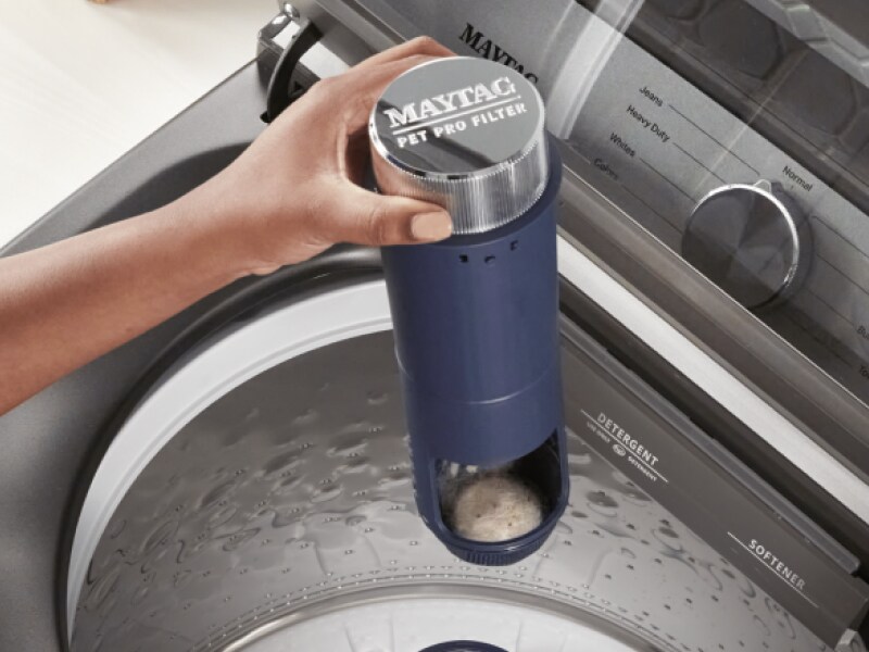 Person holding a Maytag® Pet Pro Filter Person holding a Maytag® Pet Pro Filter