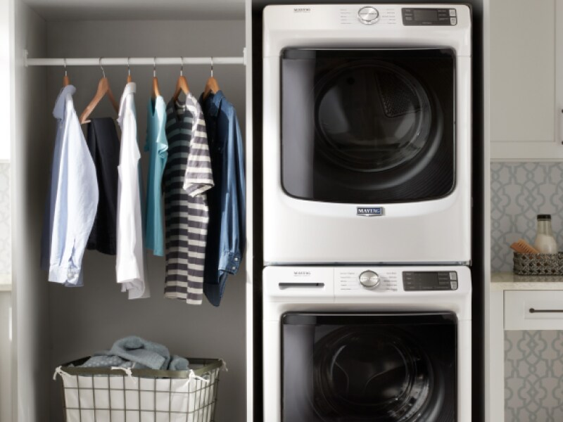 Maytag® stacked washer and dryer in a white laundry room Maytag® stacked washer and dryer in a white laundry room