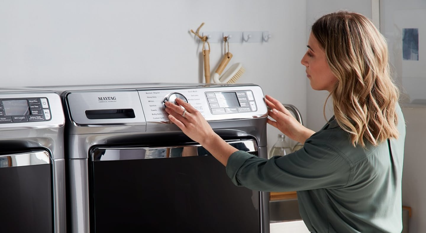 Person looking at a Maytag® washer and dryer Person looking at a Maytag® washer and dryer