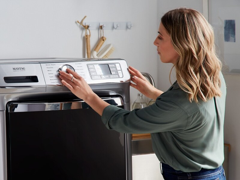 Person looking at a Maytag® washer and dryer Person looking at a Maytag® washer and dryer