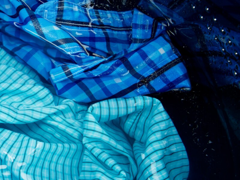 Person looking at a Maytag® washer and dryer Person looking at a Maytag® washer and dryer