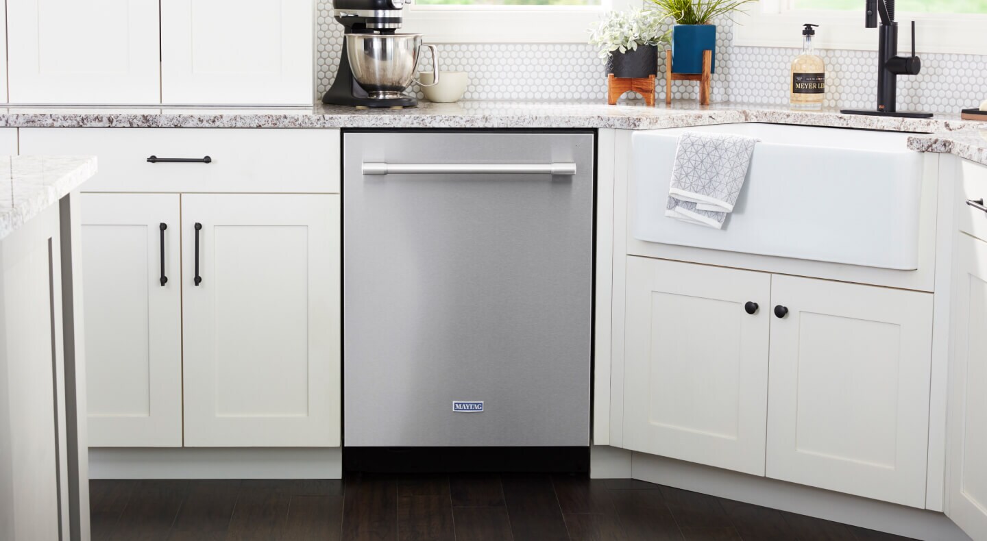 Stainless steel Maytag® Top Control Dishwasher in white cabinetry