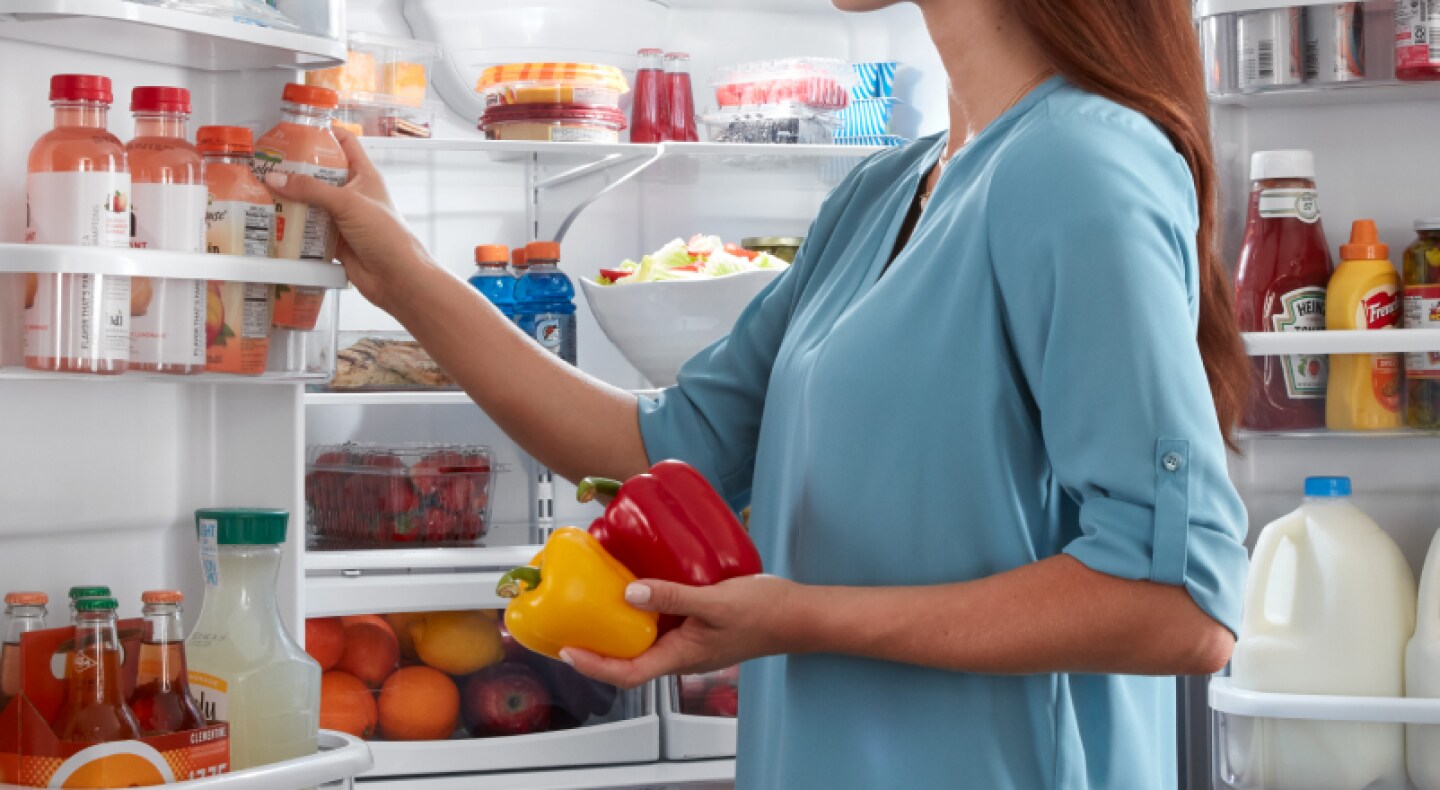 Removing items from a fully stocked refrigerator Removing items from a fully stocked refrigerator
