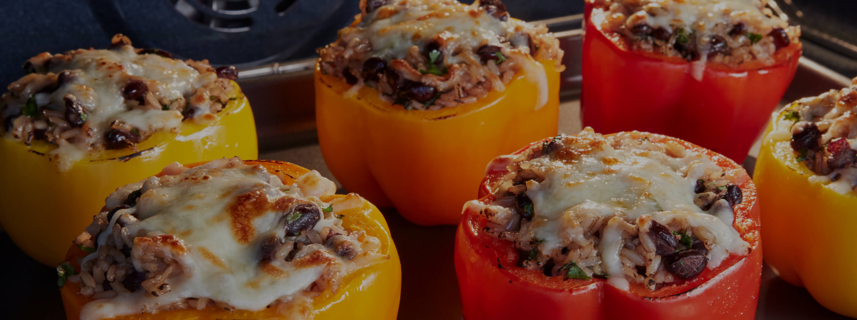 Cooked stuffed peppers in various colors