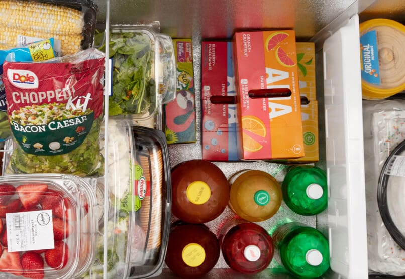 An overhead shot of an open Maytag® chest freezer with food inside.