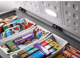 Frozen food in an open Maytag® chest freezer.