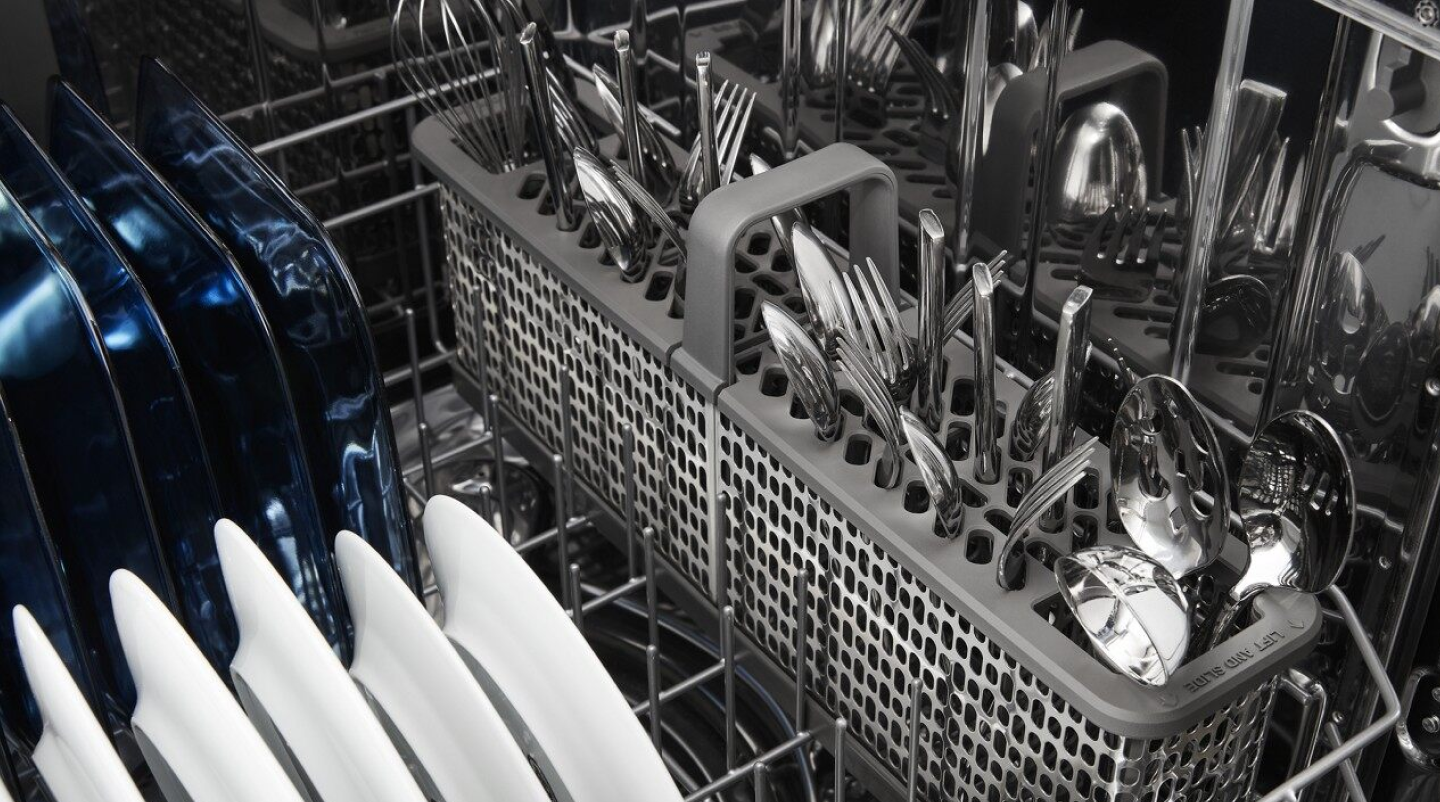 View of dishwasher bottom rack and silverware basket
