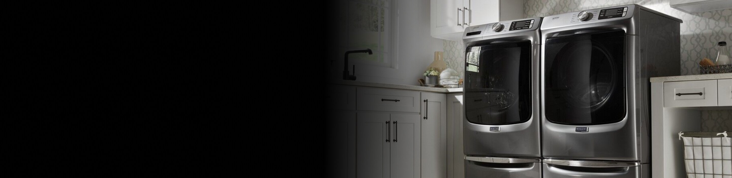 Front load laundry set in a white laundry room.