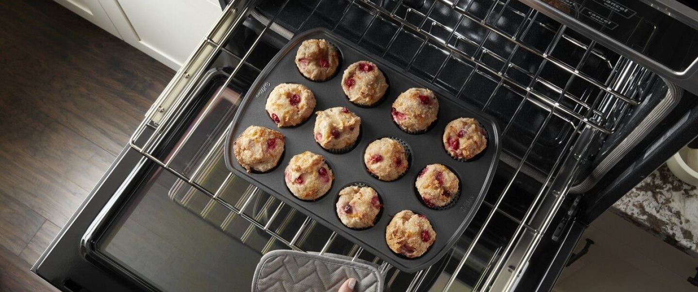 Rack of muffins going into the oven