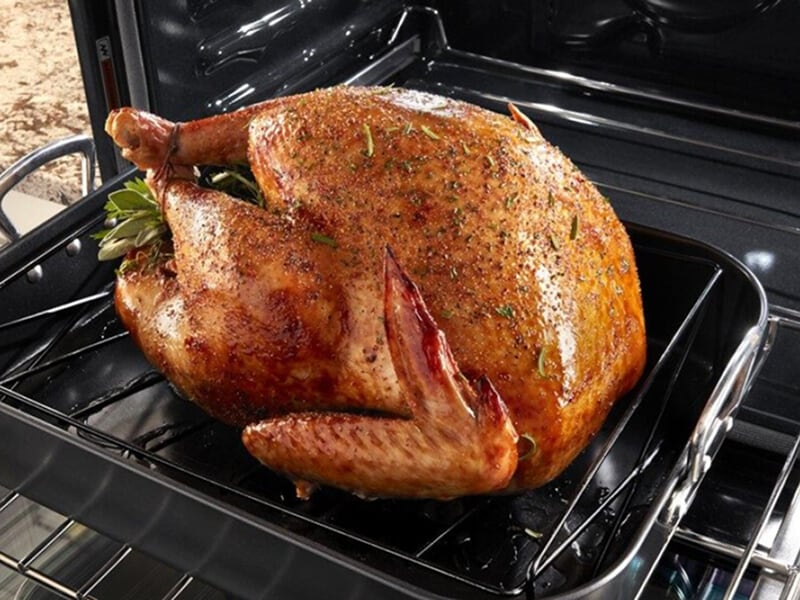 Large turkey going into the oven