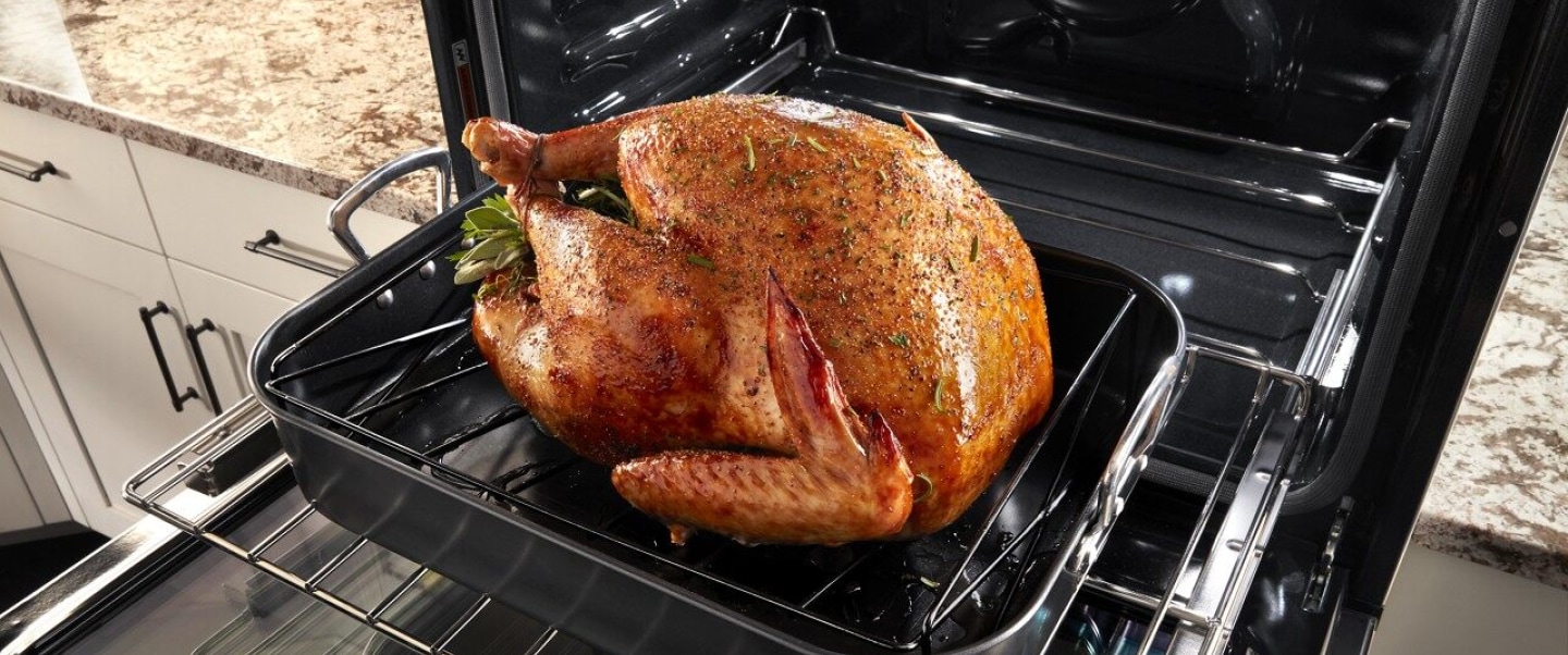 Large turkey going into the oven