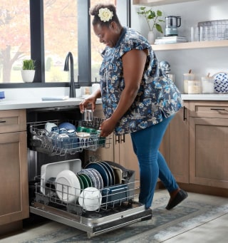 Person loading dishes in a dishwasher