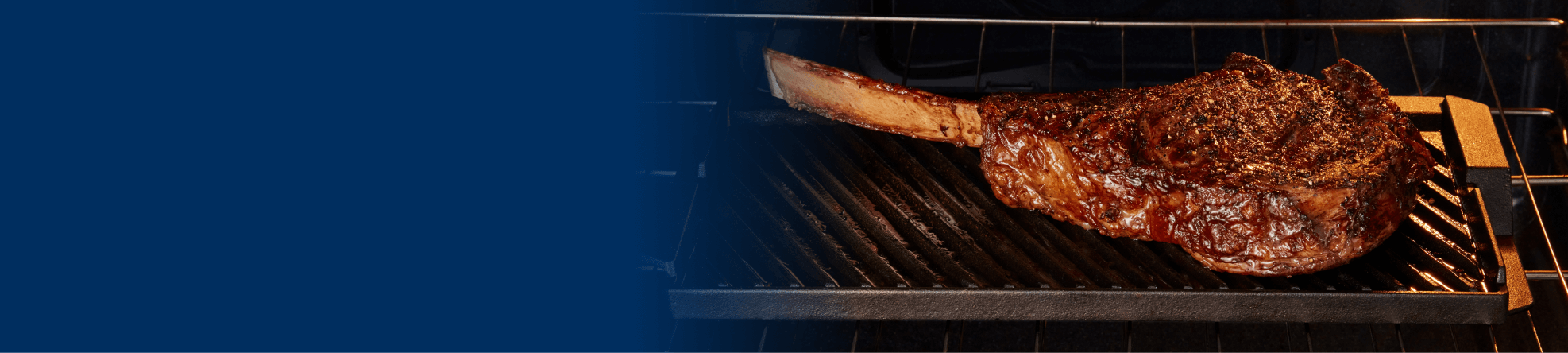 Tomahawk steak sizzling inside a Maytag® range