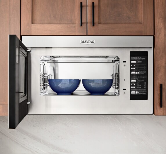 Two bowls inside a microwave.