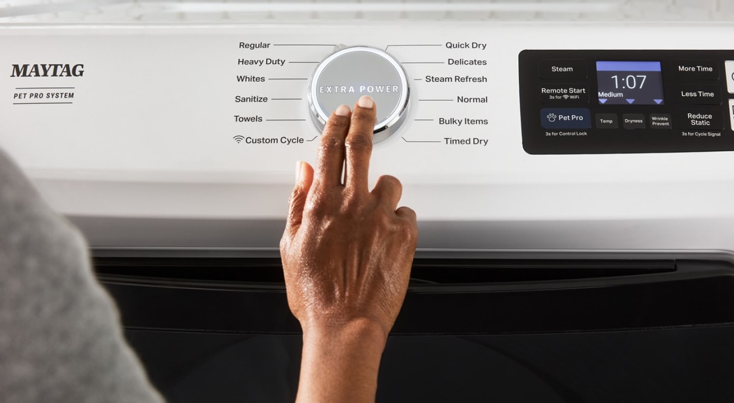  Person selecting a cycle on the Maytag® Smart Pet Pro Front Load Washer