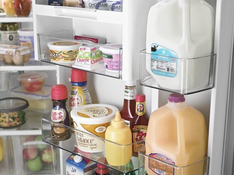 Dairy products and juice inside a refrigerator