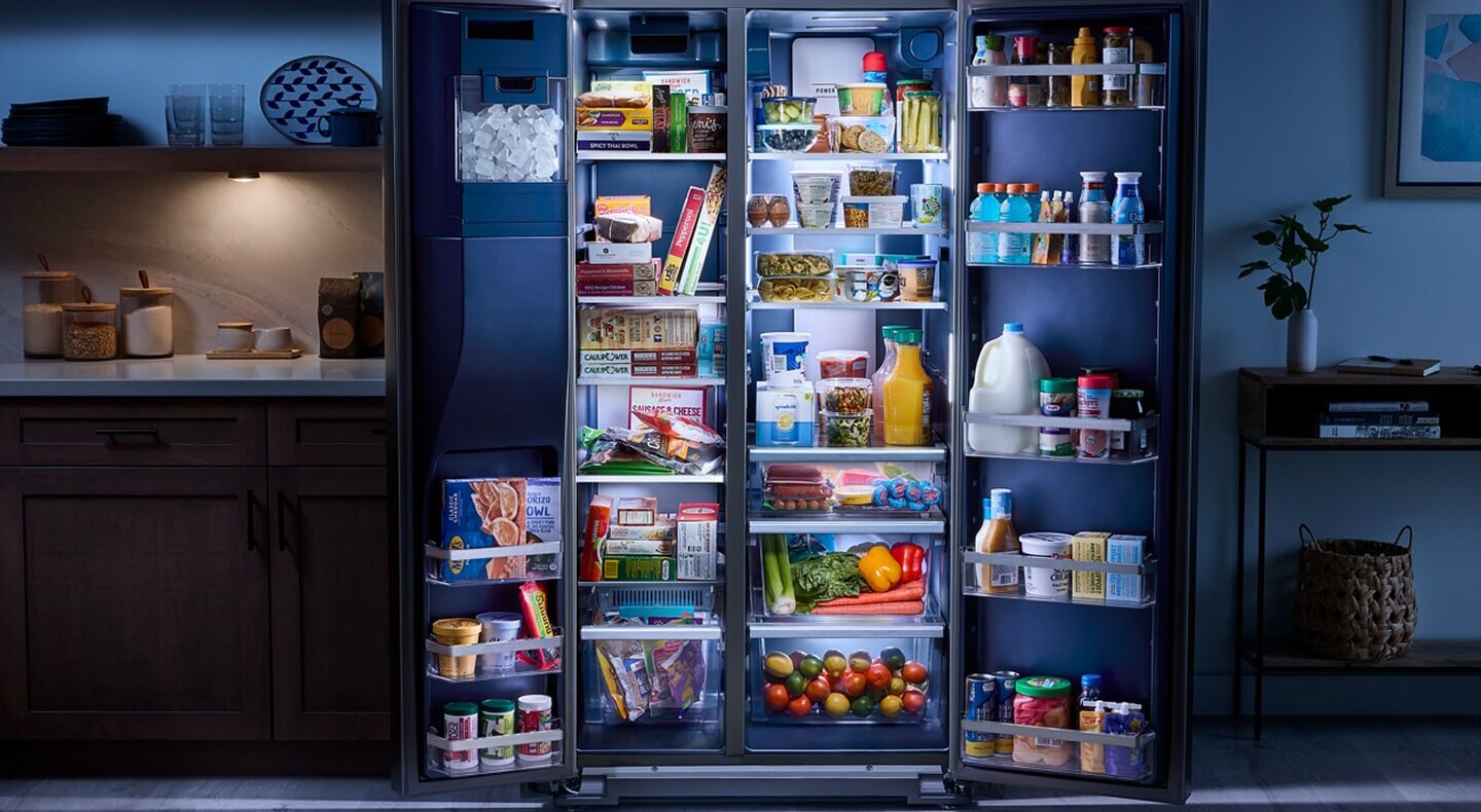 Open side-by-side refrigerator filled with groceries