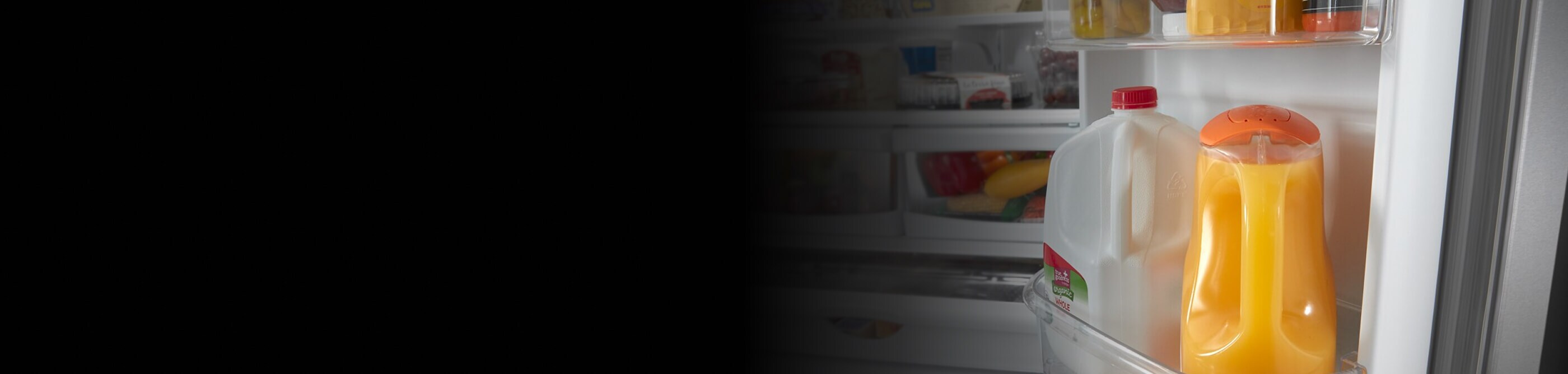 Orange juice and milk inside a refrigerator door