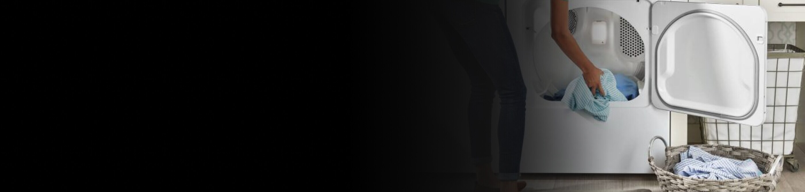 Woman loading blue shirt into a Maytag® dryer