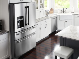 Maytag® stainless steel refrigerator in white cabinetry