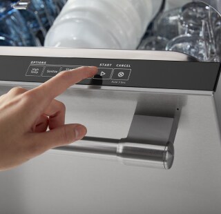 Person selecting a dishwasher cycle
