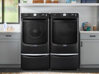 Front load washer and dryer on laundry pedestals