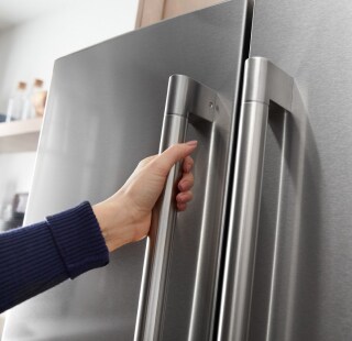 A person opening a refrigerator door