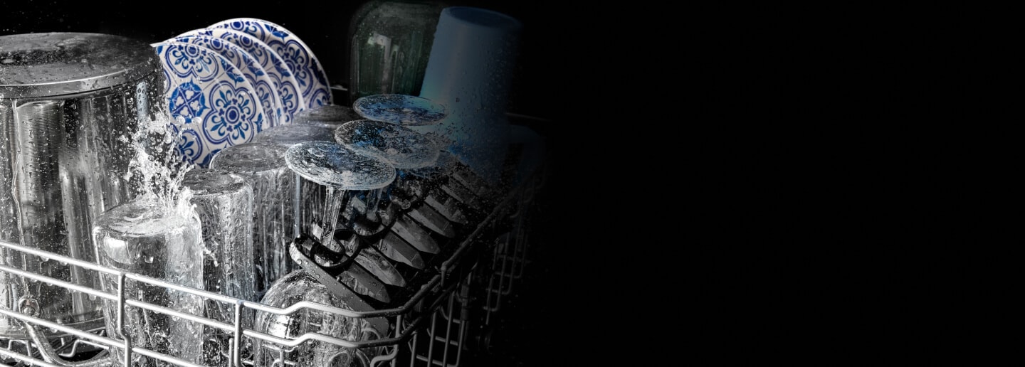 Glasses and plates being washed in a Maytag® dishwasher