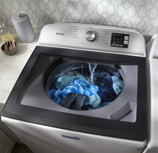 Top load washing machine running a wash cycle