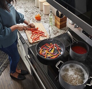Person cooking on an electric range