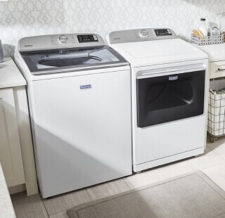 White Maytag®  washer and dryer pair in a laundry room
