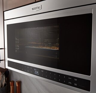 A closeup of a Maytag® microwave in a kitchen