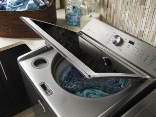 Blue clothes in an opened Maytag® washer