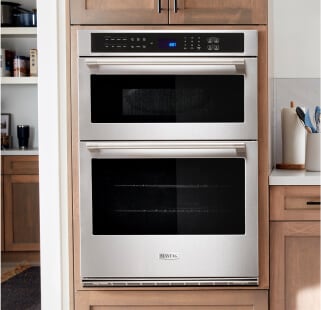 A Maytag® wall oven surrounded by brown cabinetry