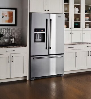 A two-door refrigerator in a kitchen