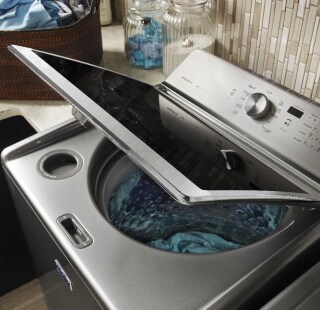 A Maytag® washer with the lid opened