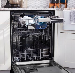 An open dishwasher with dishes inside