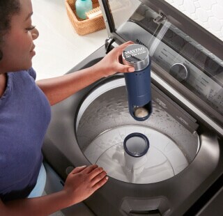 A person removing the agitator from a Maytag® washer