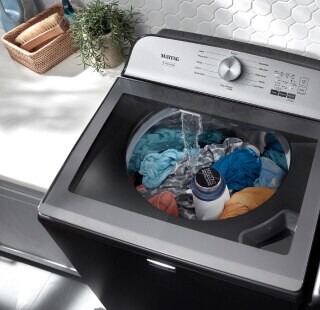 Clothes soaking in a Maytag® washer