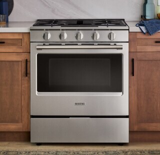 Kitchen range in brown cabinetry