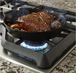 Steak and mushrooms simmering in a cast iron pan