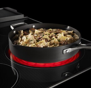 Chicken pasta cooking on an electric cooktop